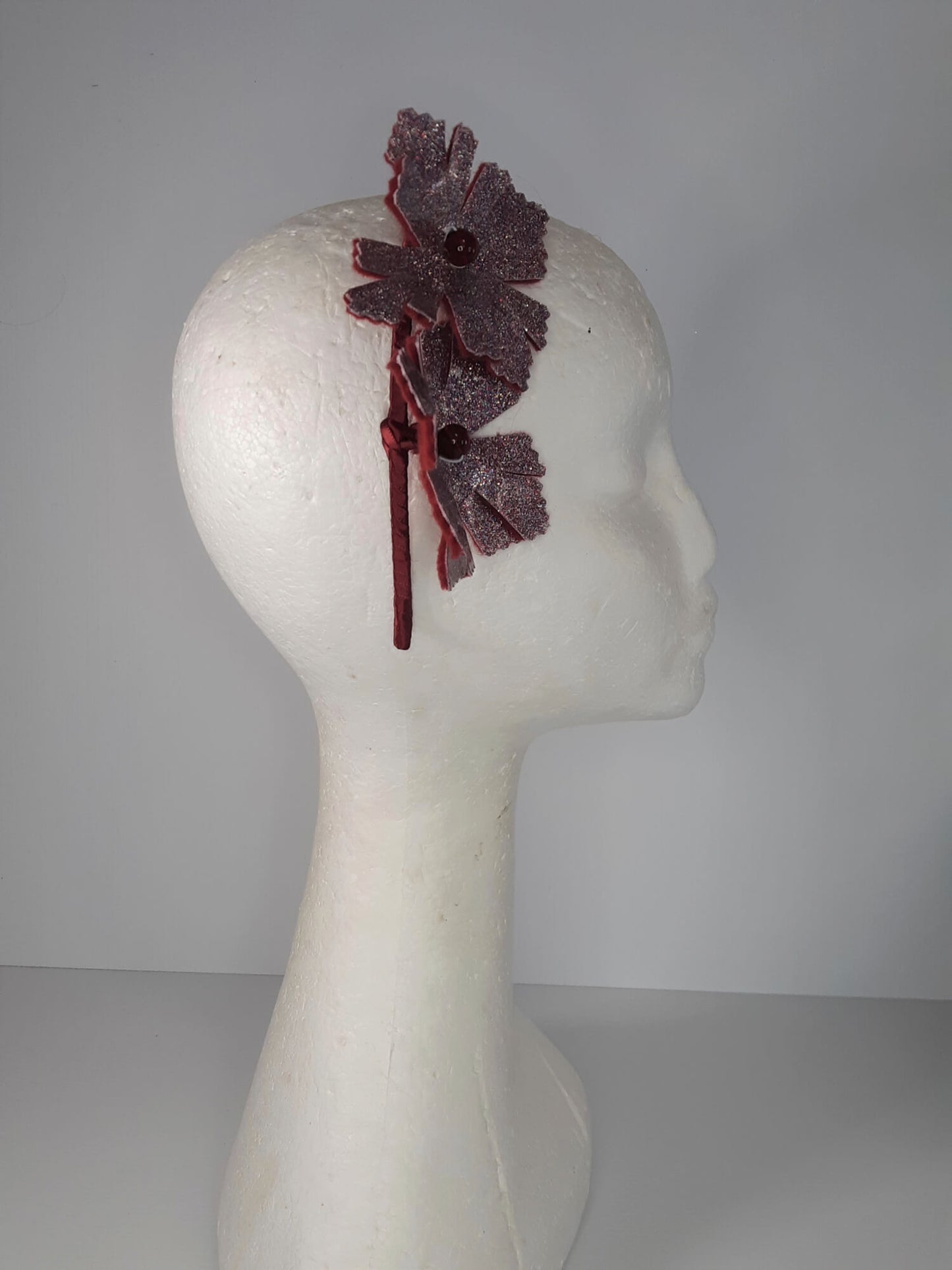 A picture of a red headband in pleather and felt by Melissa Rath Millinery.