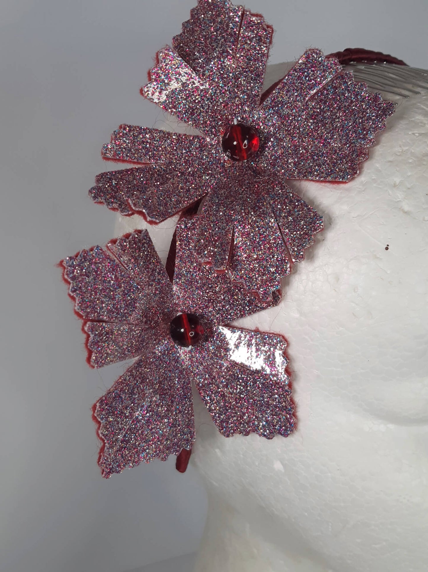 A picture of a red headband in pleather and felt by Melissa Rath Millinery.