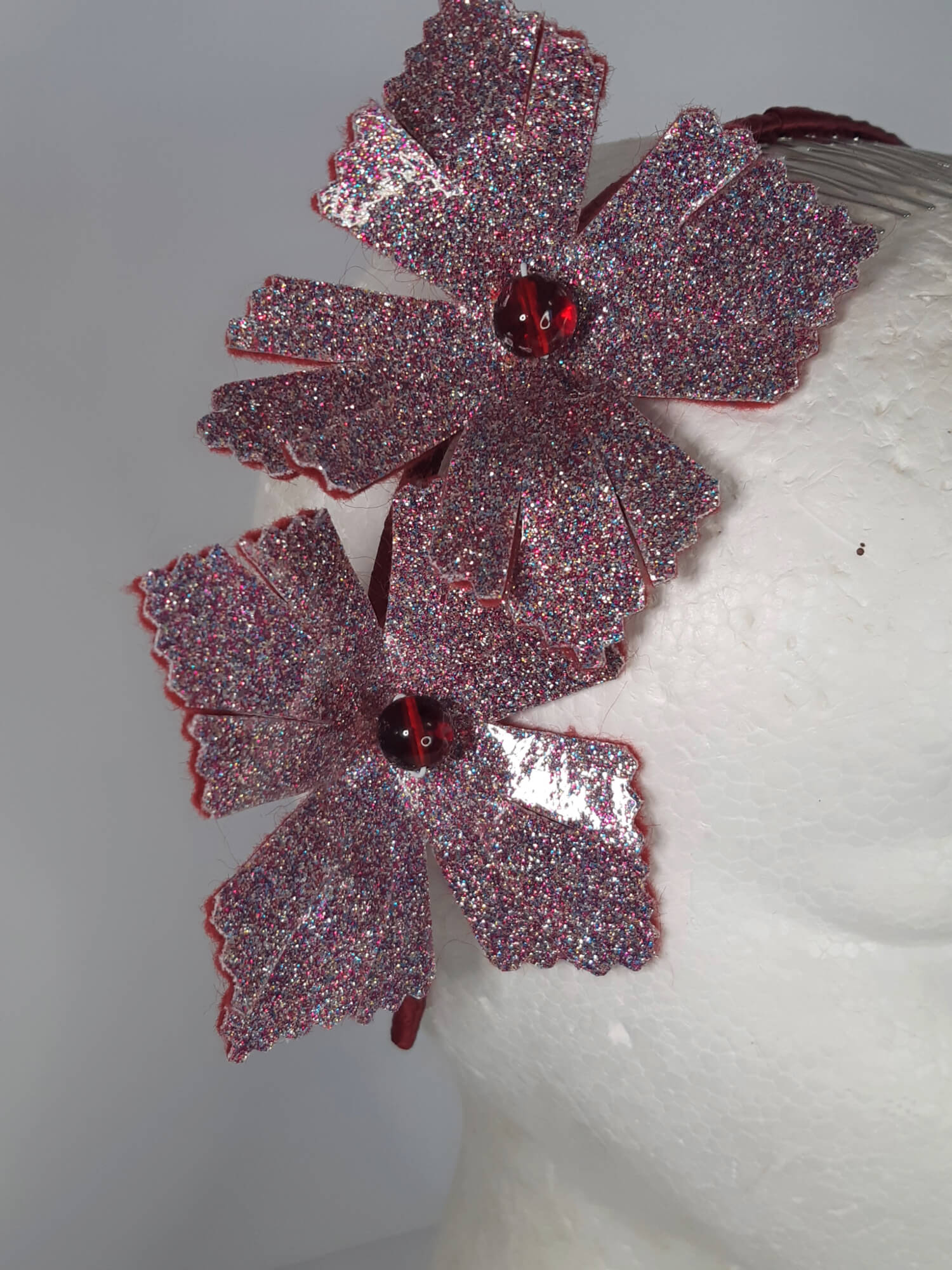 A picture of a red headband in pleather and felt by Melissa Rath Millinery.