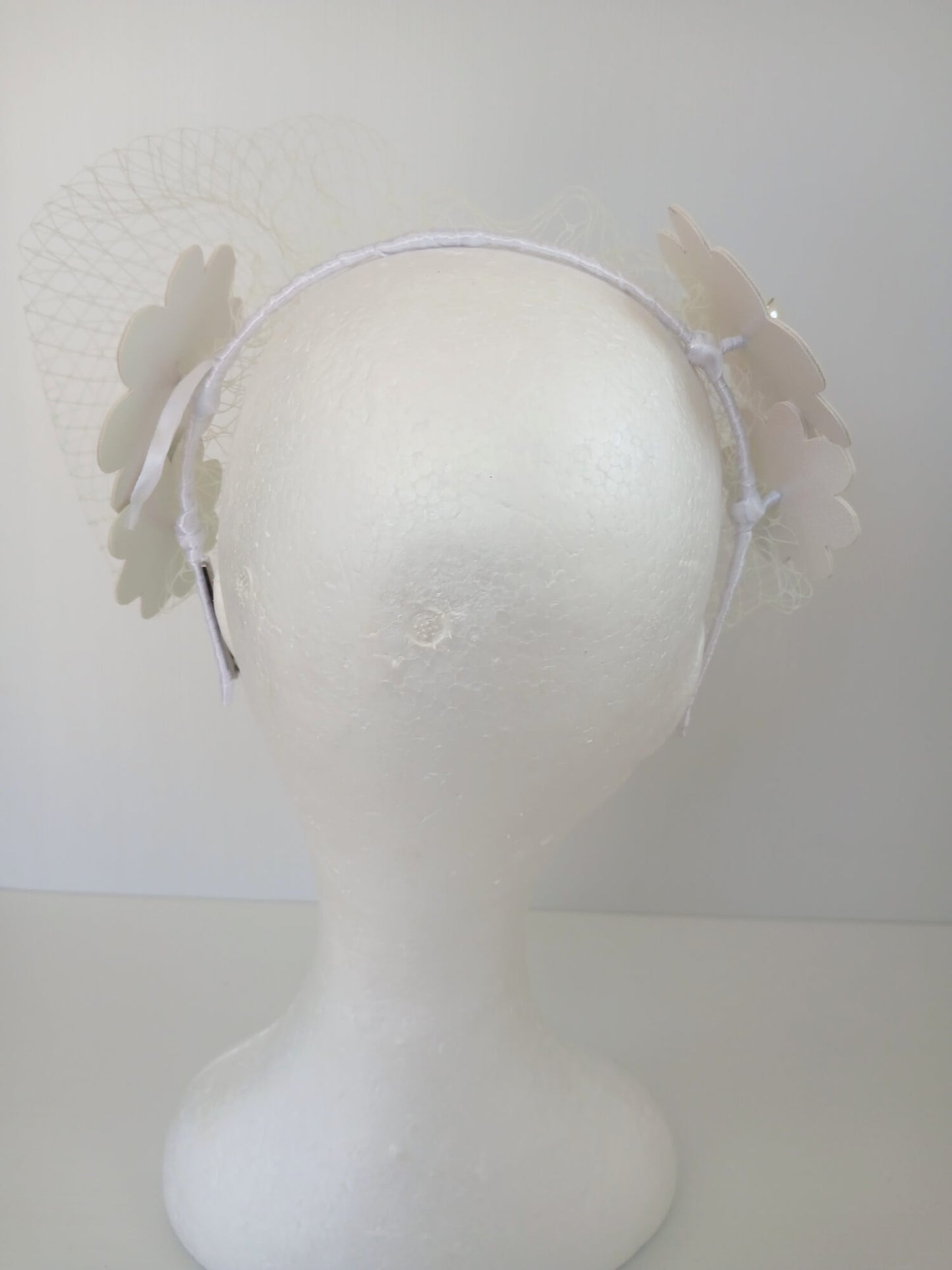 A picture of a White Pleather Veiled Millinery Headband by Melissa Rath Millinery.