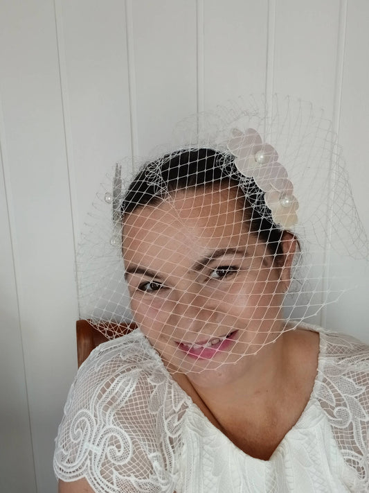 A picture of a White Pleather Veiled Millinery Headband by Melissa Rath Millinery.