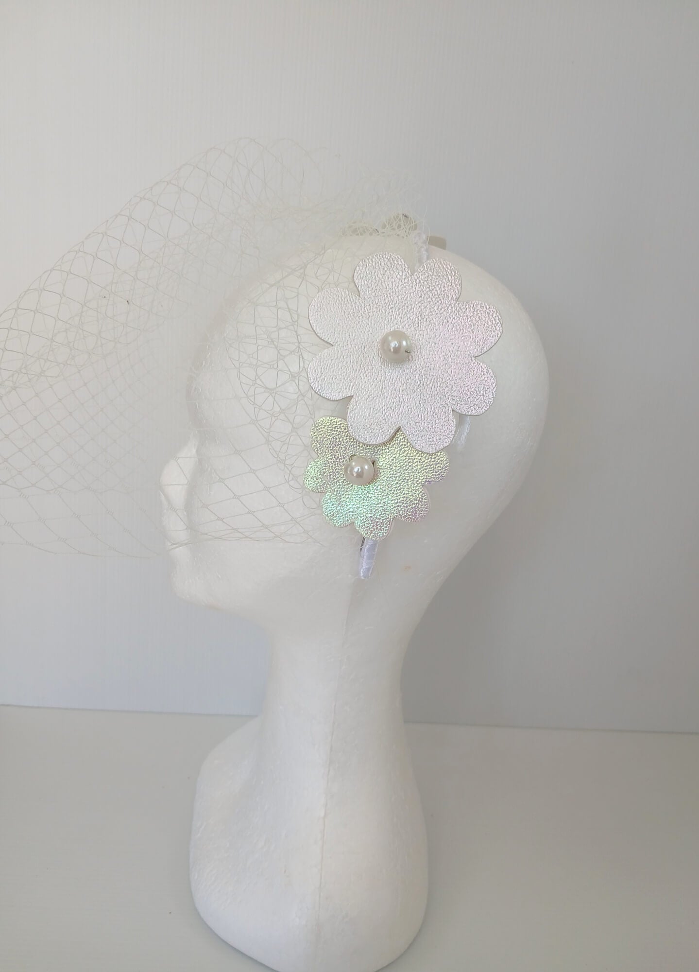 A picture of a White Pleather Veiled Millinery Headband by Melissa Rath Millinery.