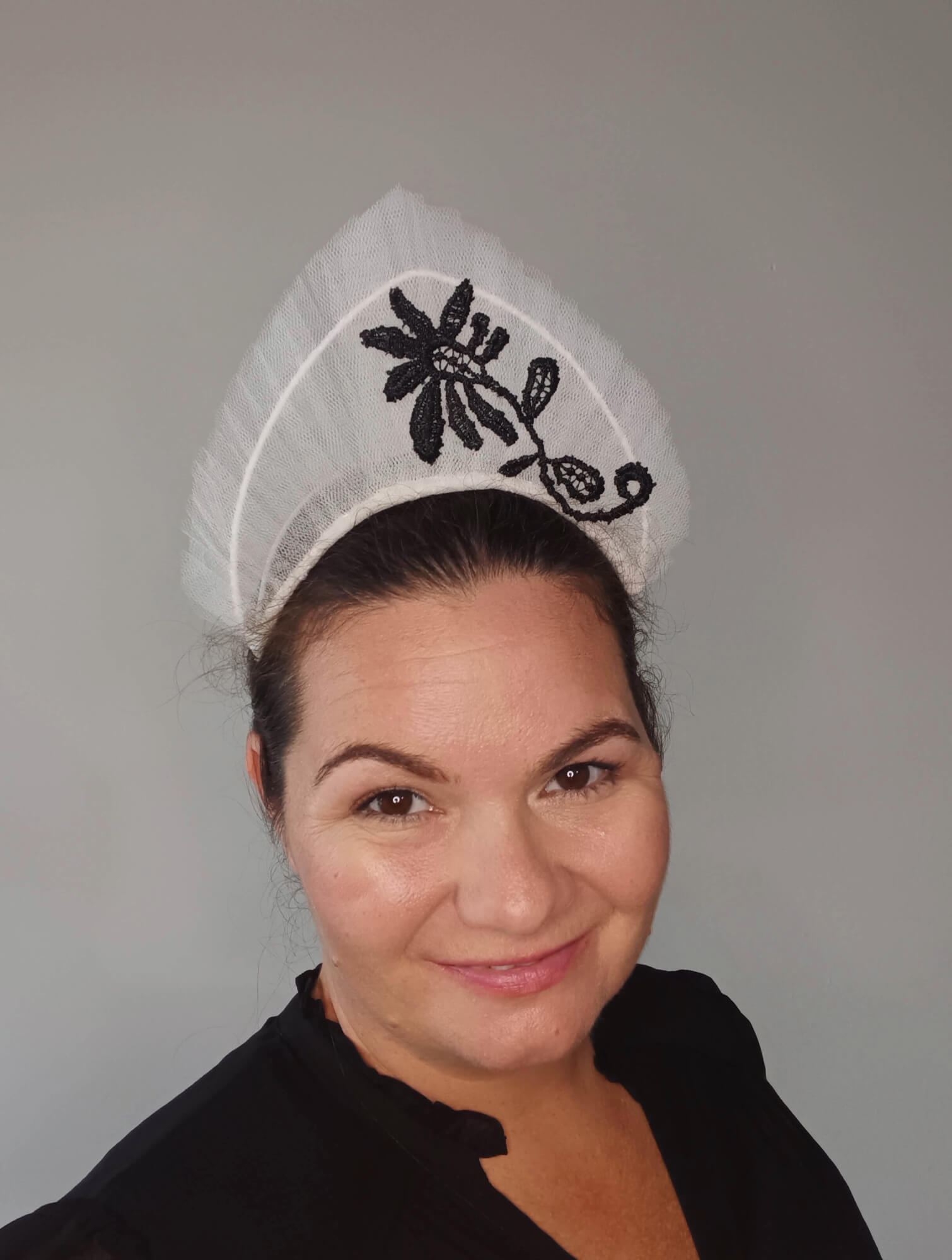 A picture of a white tulle crown by Melissa Rath Millinery.