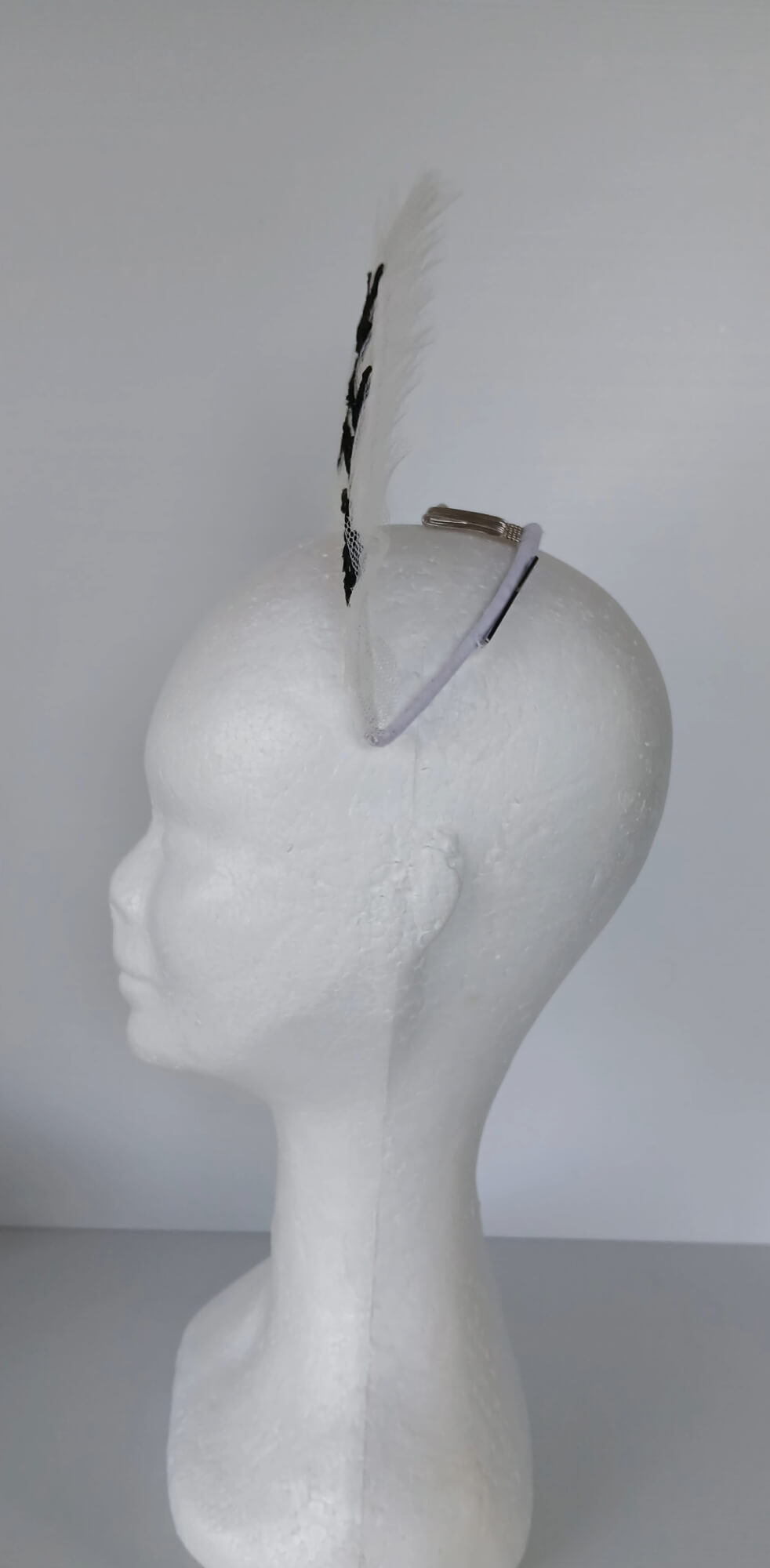 A picture of a white tulle crown by Melissa Rath Millinery.
