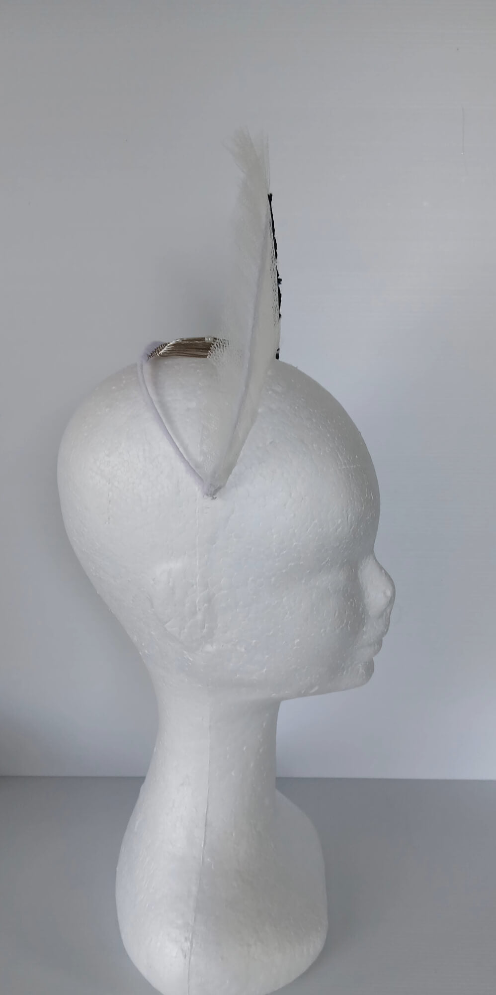 A picture of a white tulle crown by Melissa Rath Millinery.