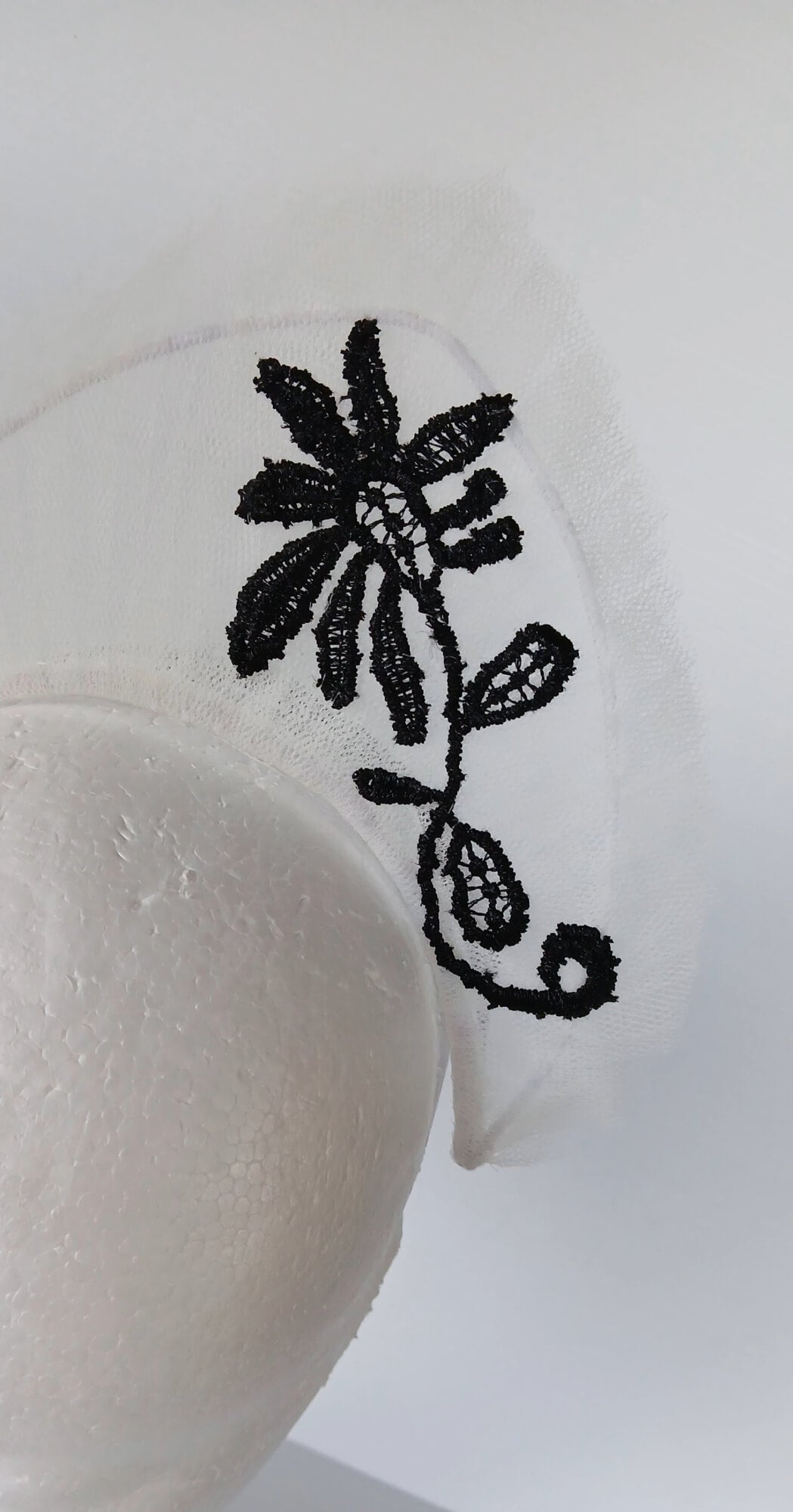 A picture of a white tulle crown by Melissa Rath Millinery.