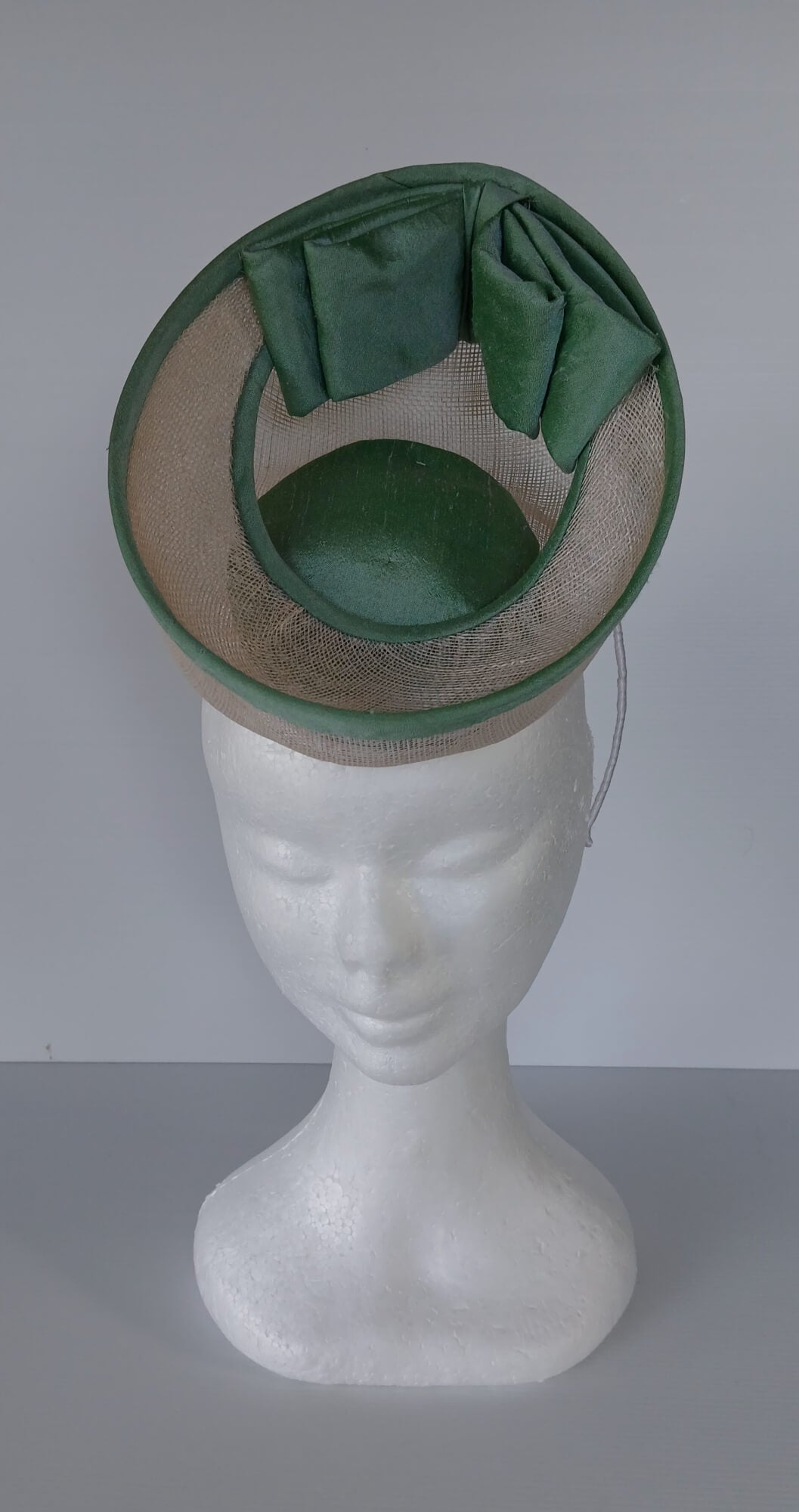 A picture of a White and Green Saucer Hat by Melissa Rath Millinery
