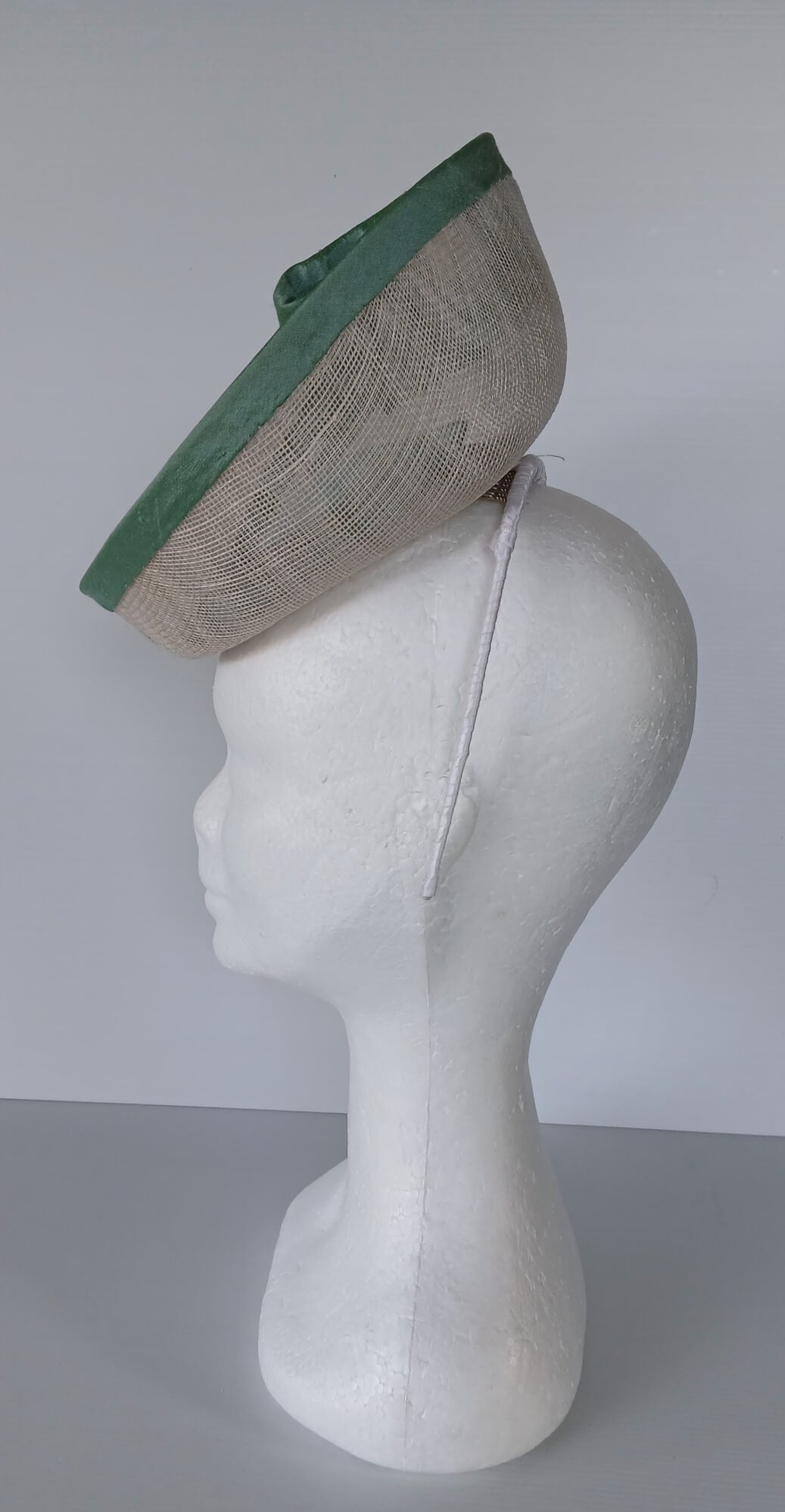 A picture of a White and Green Saucer Hat by Melissa Rath Millinery