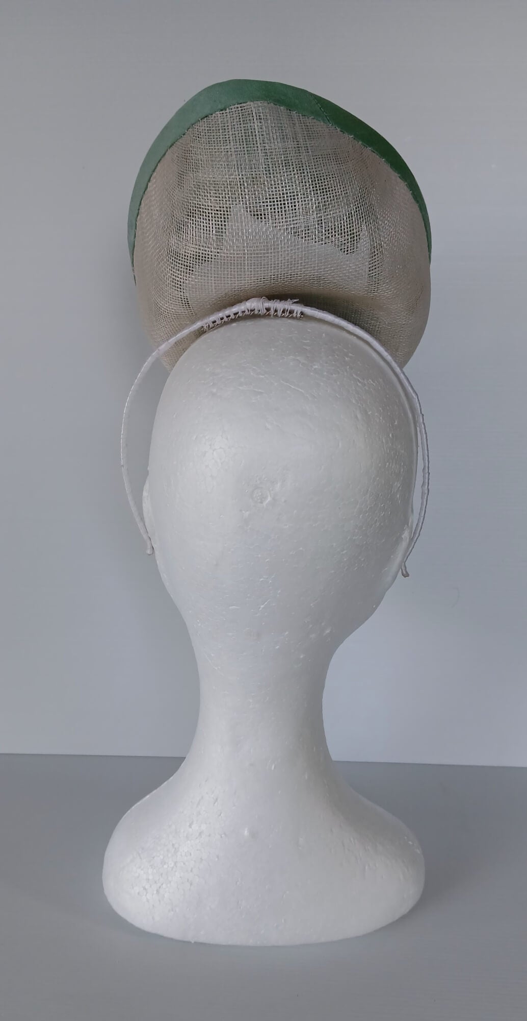 A picture of a White and Green Saucer Hat by Melissa Rath Millinery