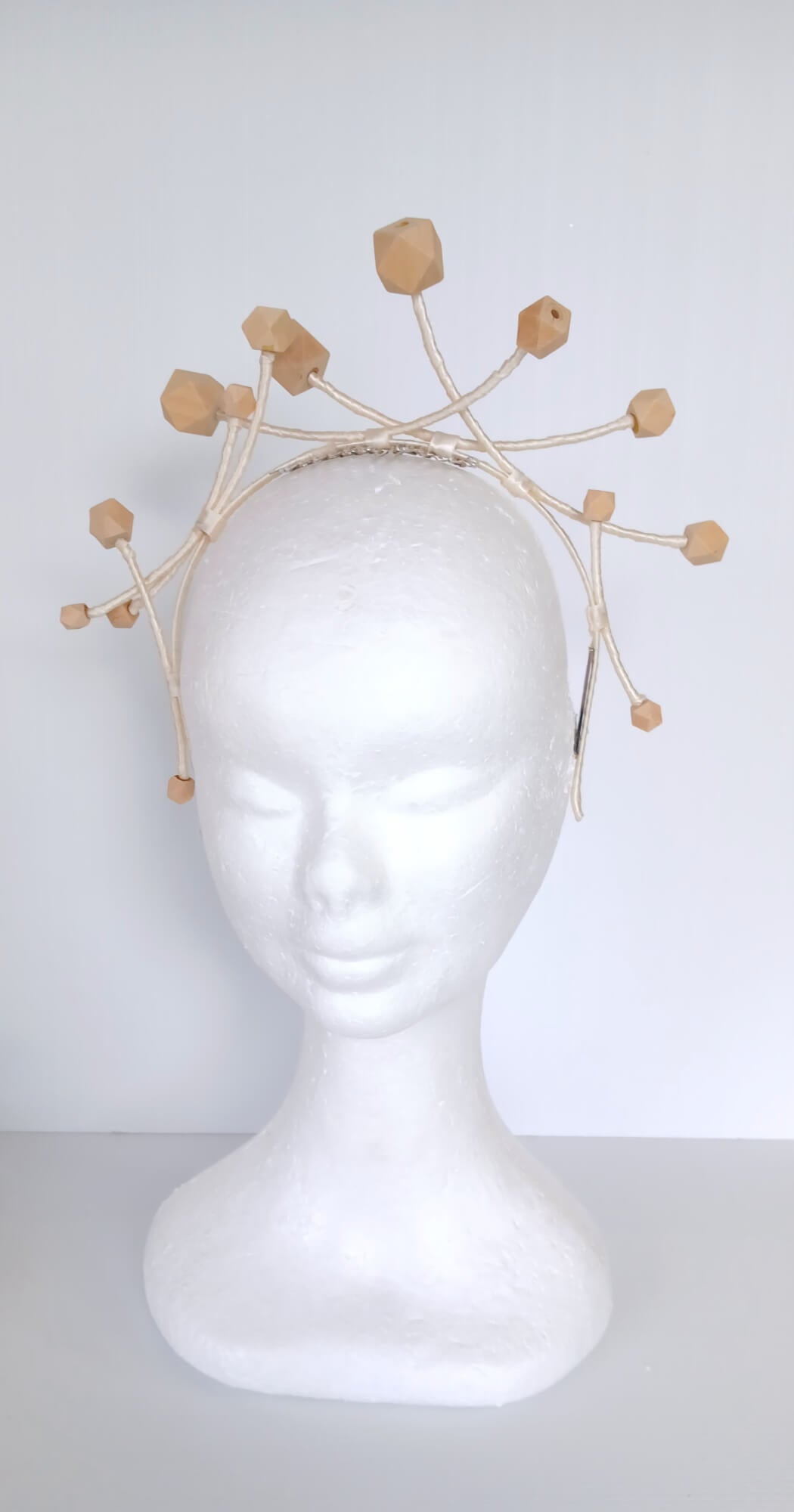 A picture of a Wooden Beaded Millinery Headband by Melissa Rath Millinery
