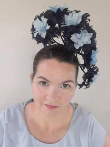 A picture of a light blue and navy floating feather millinery headpiece by Melissa Rath Millinery.