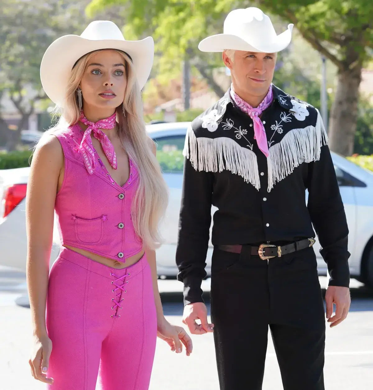 A picture of Margot Robbie as Barbie and Ryan Gosling as Ken in a "cowboy" clothes and coordinating cowboy hats