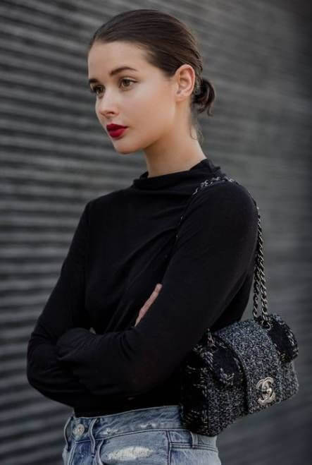 A picture of a woman with a red lip with a neutral outfit. This combination makes the red pop and introduces a hint of colour.