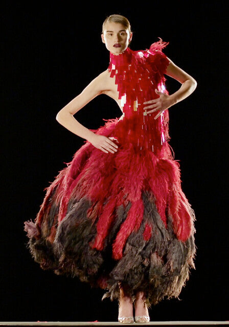 A picture of a model wearing a feathered dress by designer Alexander McQueen