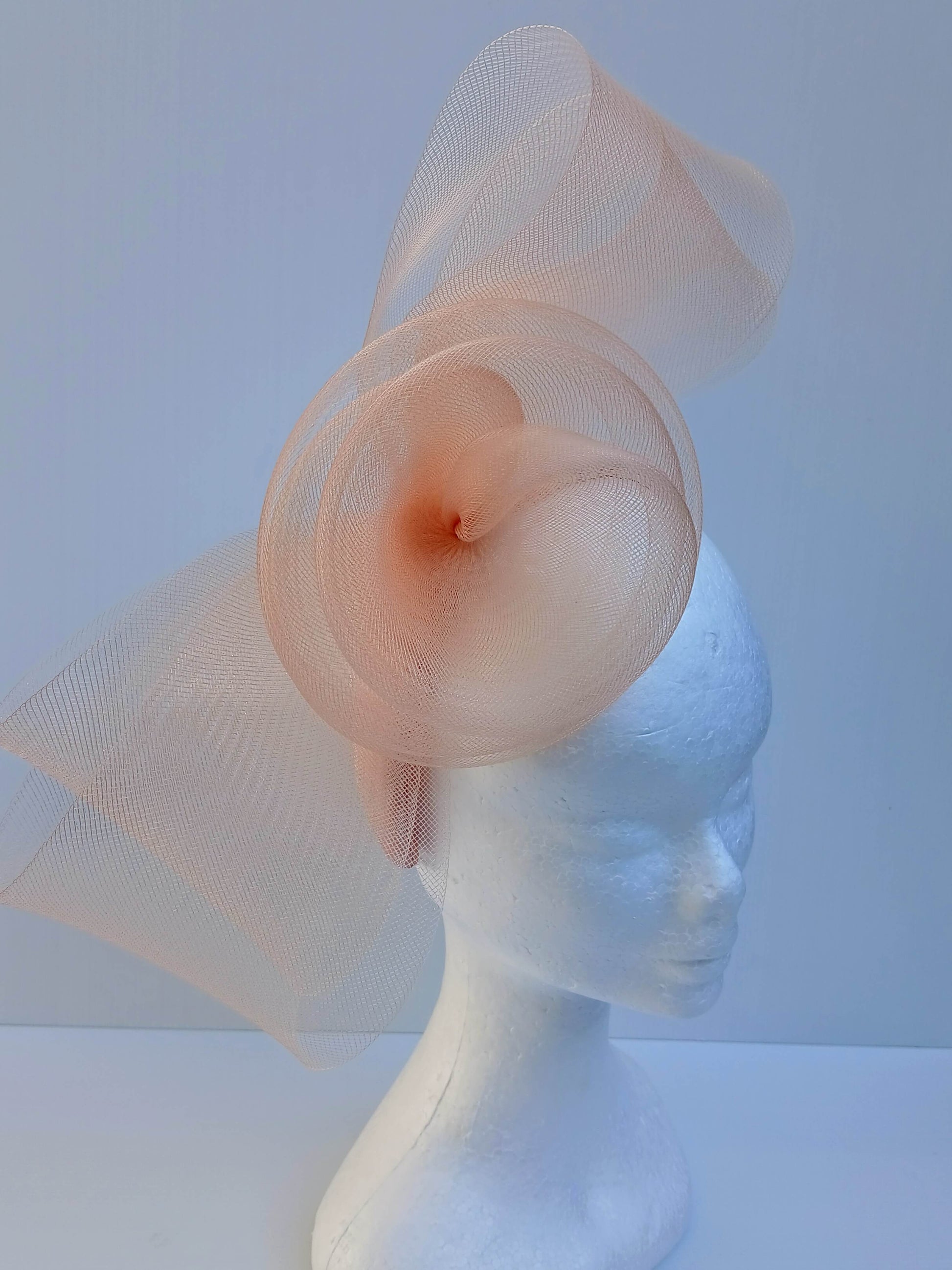 A picture  of an Apricot Crinoline Bow and Rose Headband by Melissa Rath Millinery