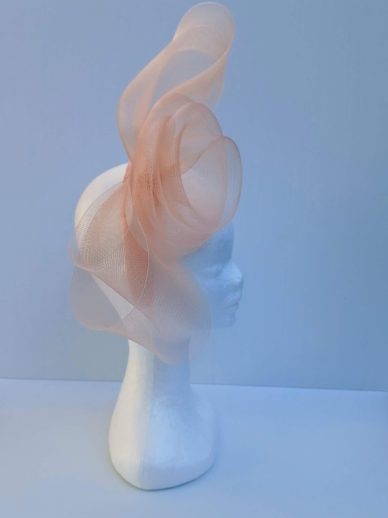 A picture  of an Apricot Crinoline Bow and Rose Headband by Melissa Rath Millinery.
