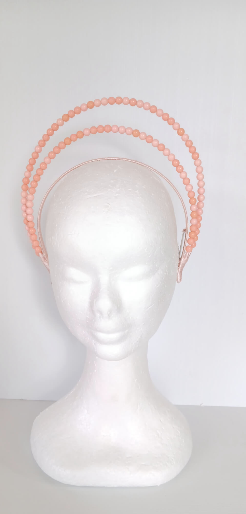 A picture of an Apricot Beaded Headband by Melissa Rath Millinery.