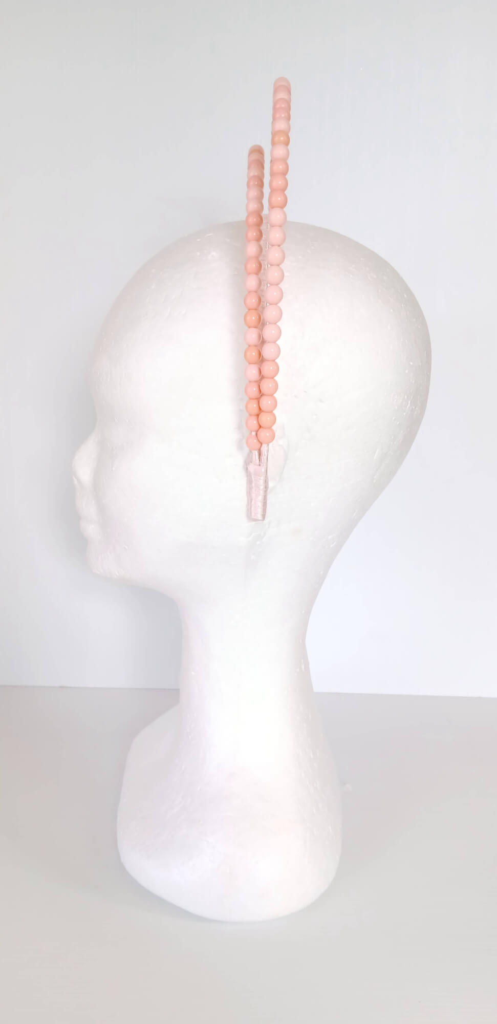 A picture of an Apricot Beaded Headband by Melissa Rath Millinery.