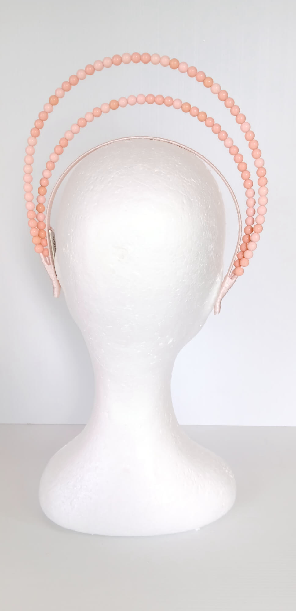 A picture of an Apricot Beaded Headband by Melissa Rath Millinery.