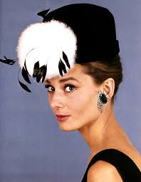 A picture of actress Audrey Hepburn wearing a black and white feathered hat in the movie Funny Faces