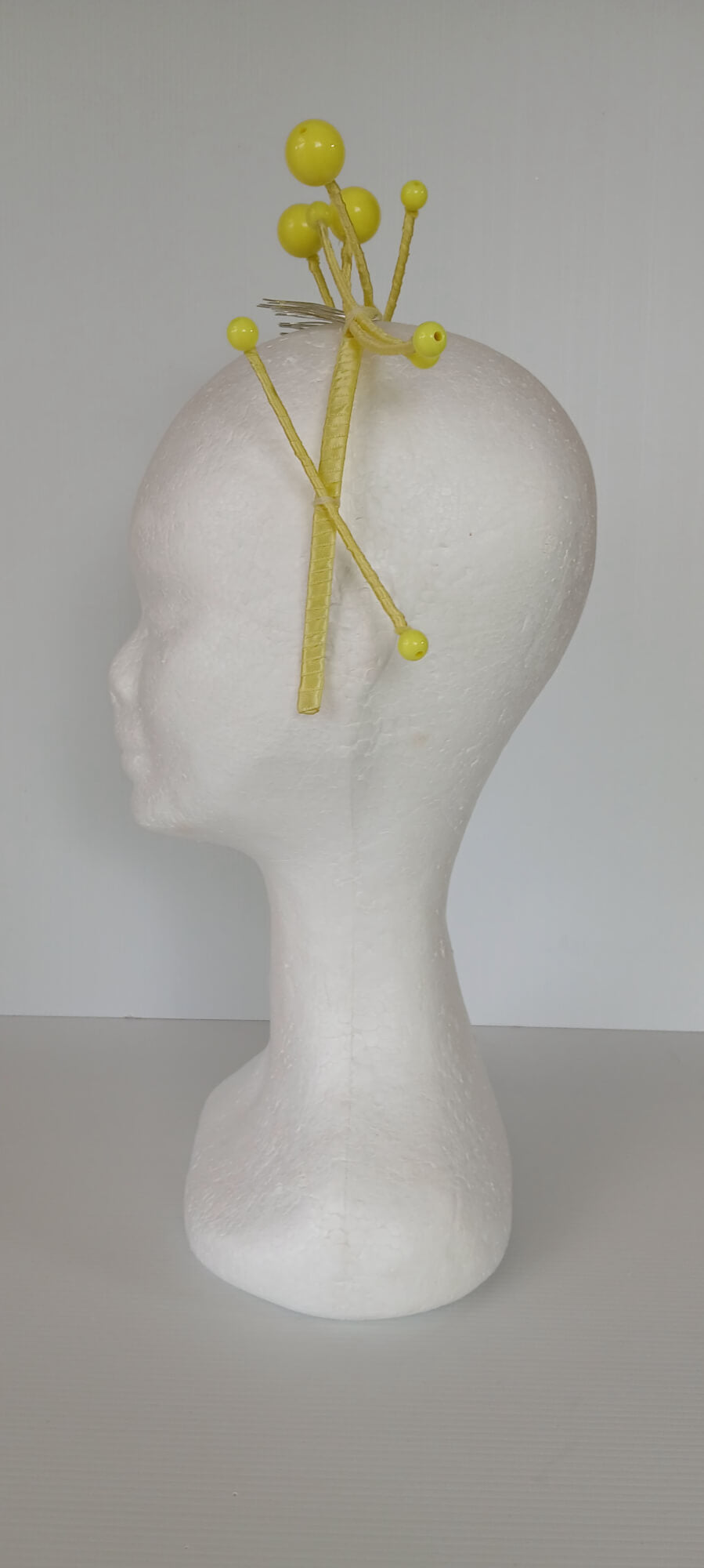A picture of a yellow beaded  millinery headband by Melissa Rath Millinery.