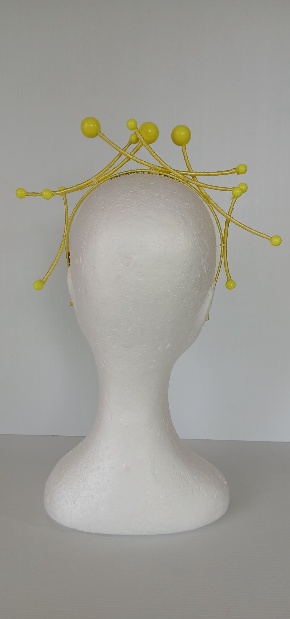 A picture of a yellow beaded  millinery headband by Melissa Rath Millinery.