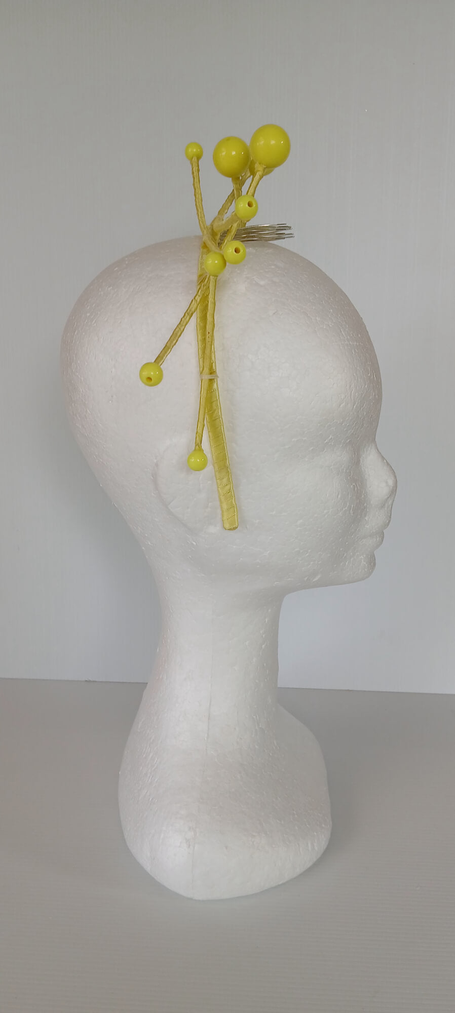 A picture of a yellow beaded  millinery headband by Melissa Rath Millinery.