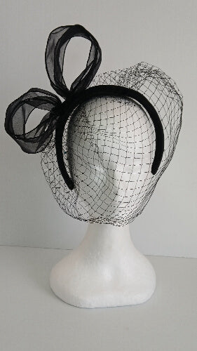 A picture of a  black satin veiled headband by Melissa Rath Millinery.