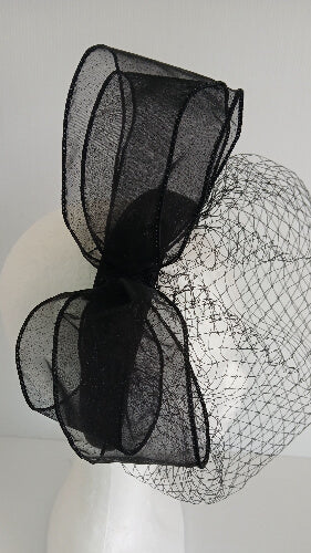 A picture of a  black satin veiled headband by Melissa Rath Millinery.