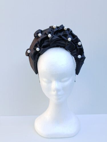 An image of a Black Smocked Satin Crown by Melissa Rath Millinery