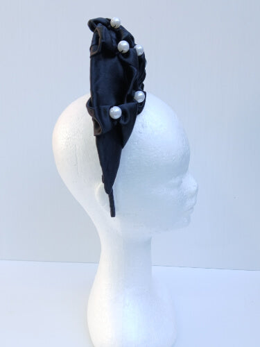 An image of a Black Smocked Satin Crown by Melissa Rath Millinery
