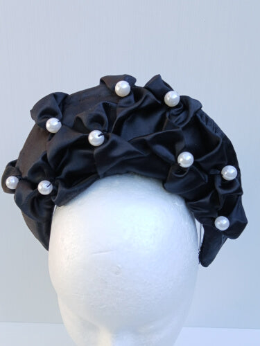 An image of a Black Smocked Satin Crown by Melissa Rath Millinery