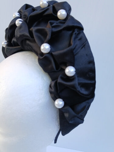 An image of a Black Smocked Satin Crown by Melissa Rath Millinery