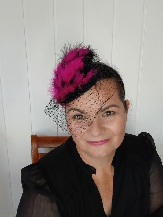A picture of a Pink and Black Veiled and Feathered Millinery Fascinator by Melissa Rath Millinery.