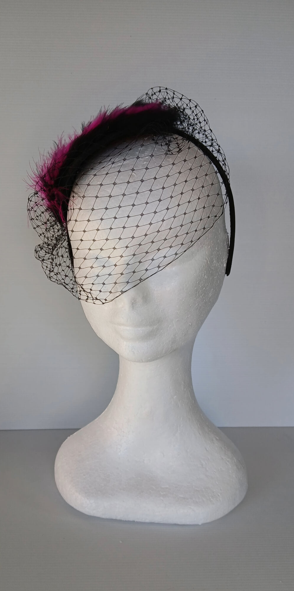A picture of a Pink and Black Veiled and Feathered Millinery Fascinator by Melissa Rath Millinery.