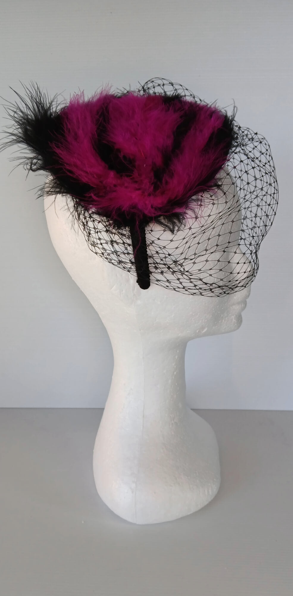 A picture of a Pink and Black Veiled and Feathered Millinery Fascinator by Melissa Rath Millinery.