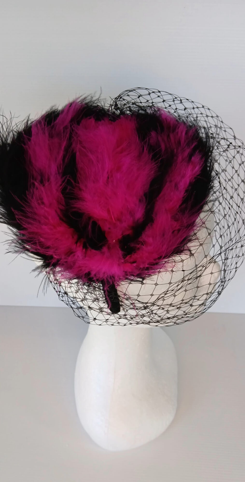 A picture of a Pink and Black Veiled and Feathered Millinery Fascinator by Melissa Rath Millinery.