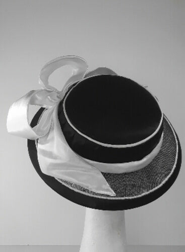A picture of a Black and White Millinery Boater by Melissa Rath Millinery