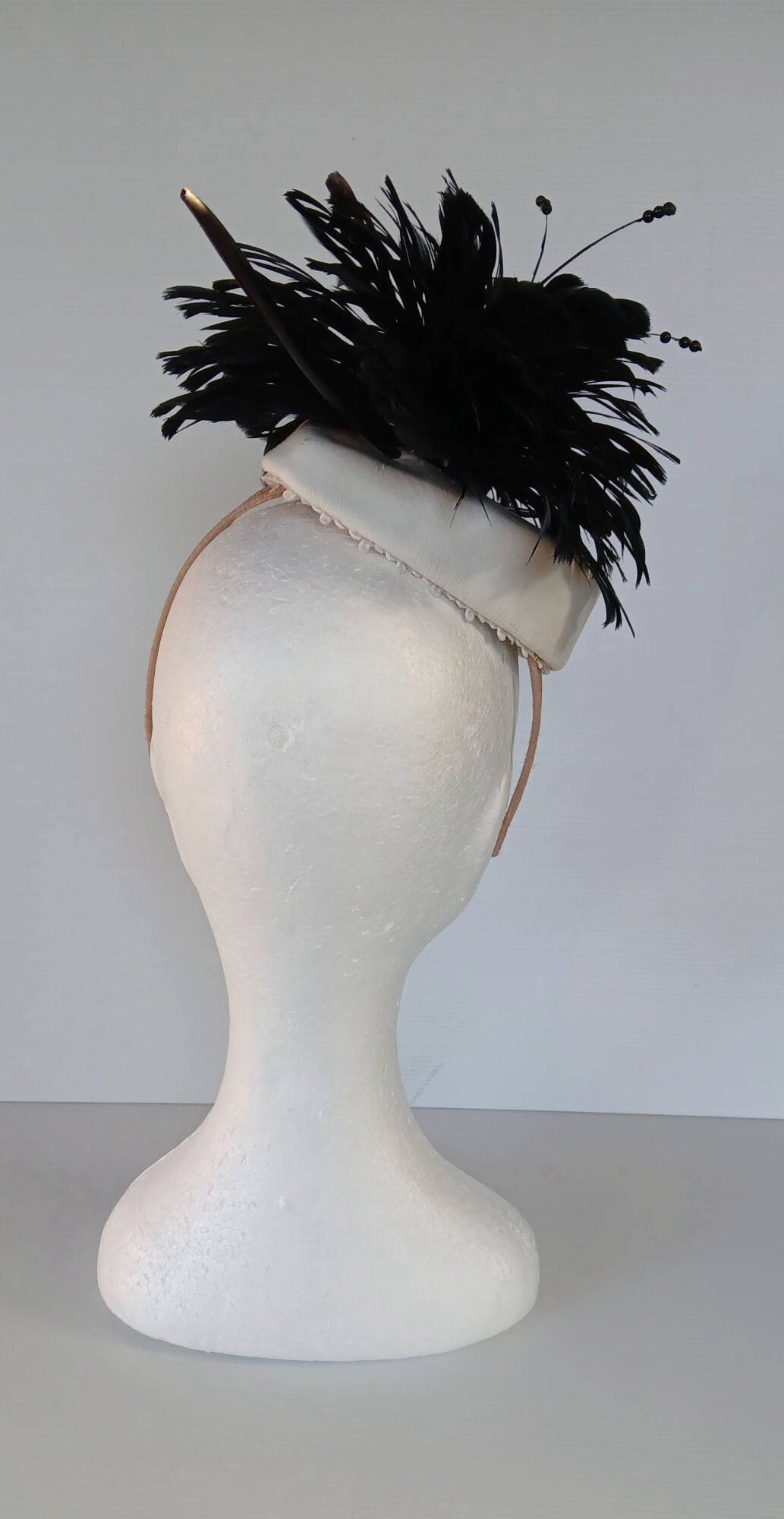 A picture of a Black and White Leather Millinery Headpiece by Melissa Rath Millinery.