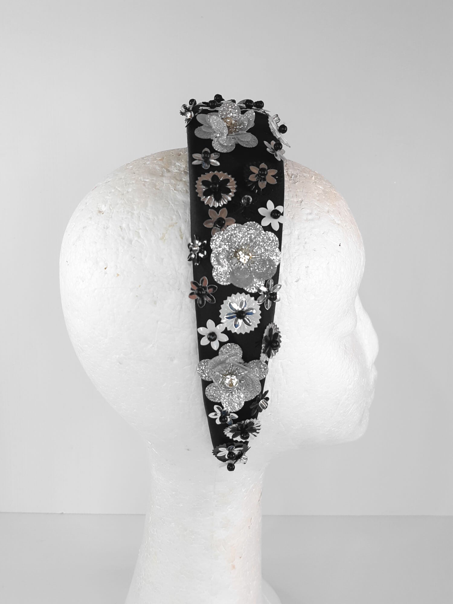 A picture of a Black, White and Silver Padded Headband by Melissa Rath Millinery.