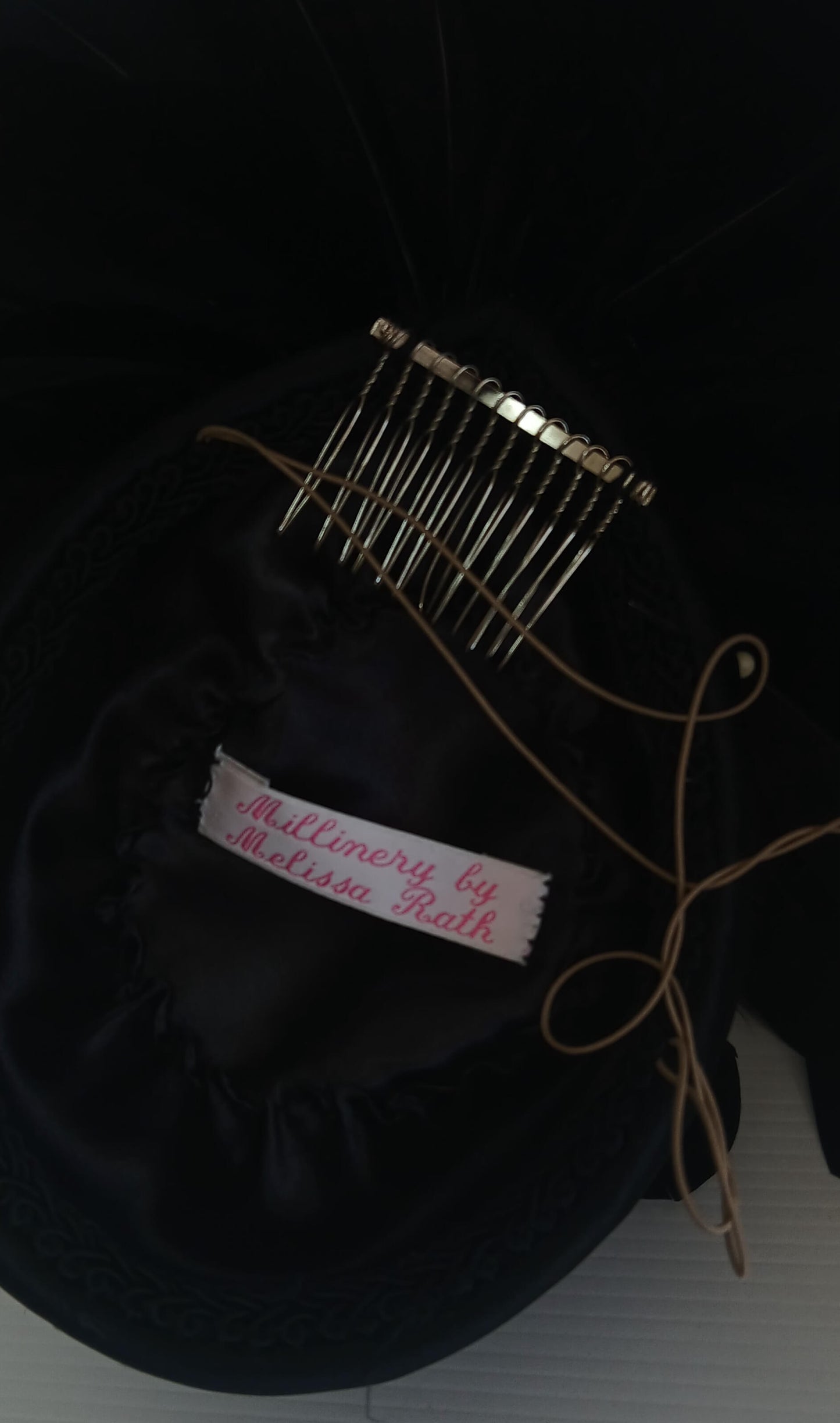 An image of the Black Satin Fascinator with Floral Flower Trim by Melissa Rath Millinery