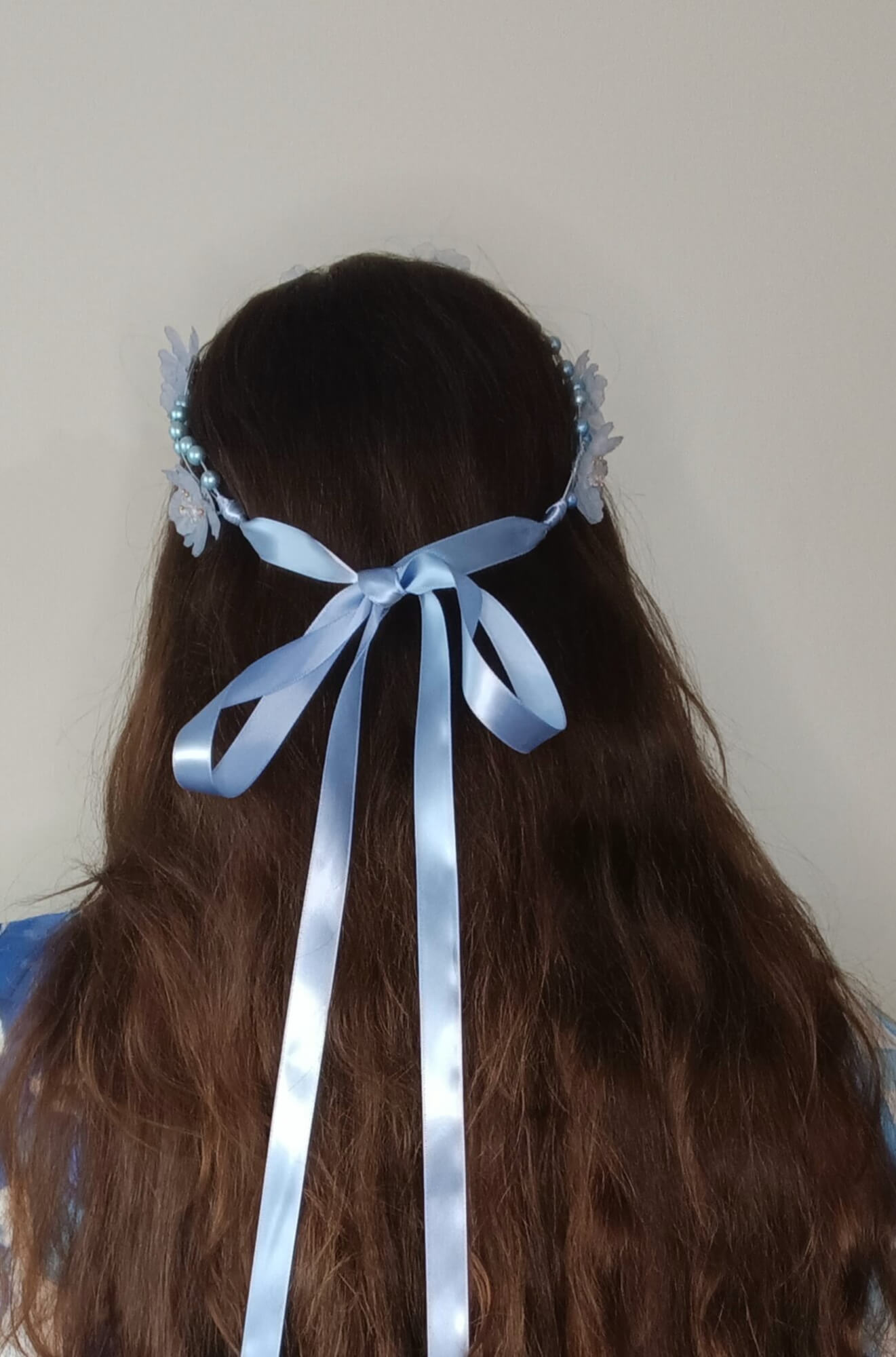 A picture of a pale blue halo headband by Melissa Rath Millinery