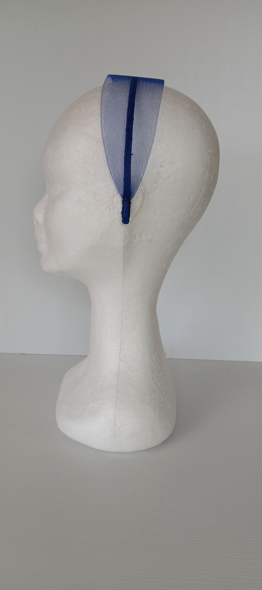 A picture of a blue crinoline headband by Melissa Rath Millinery.