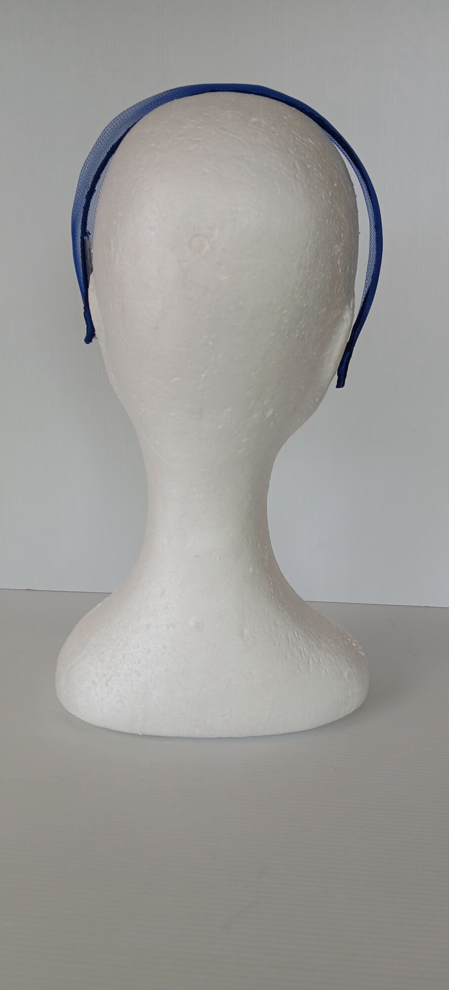A picture of a blue crinoline headband by Melissa Rath Millinery.