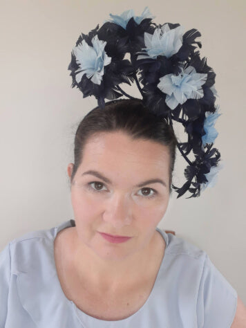 A picture of a Blue Floating Feather Millinery Headpiece by Melissa Rath Millinery.