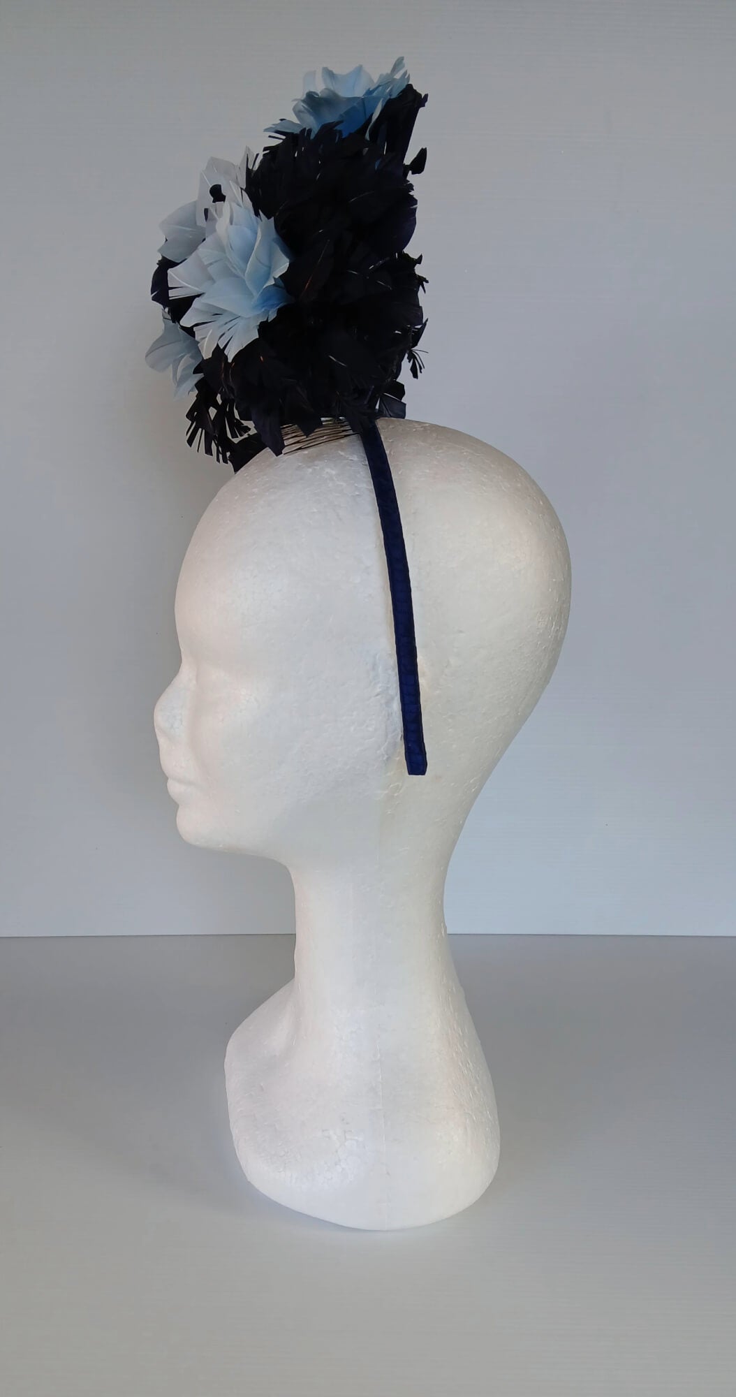 A picture of a Blue Floating Feather Millinery Headpiece by Melissa Rath Millinery.