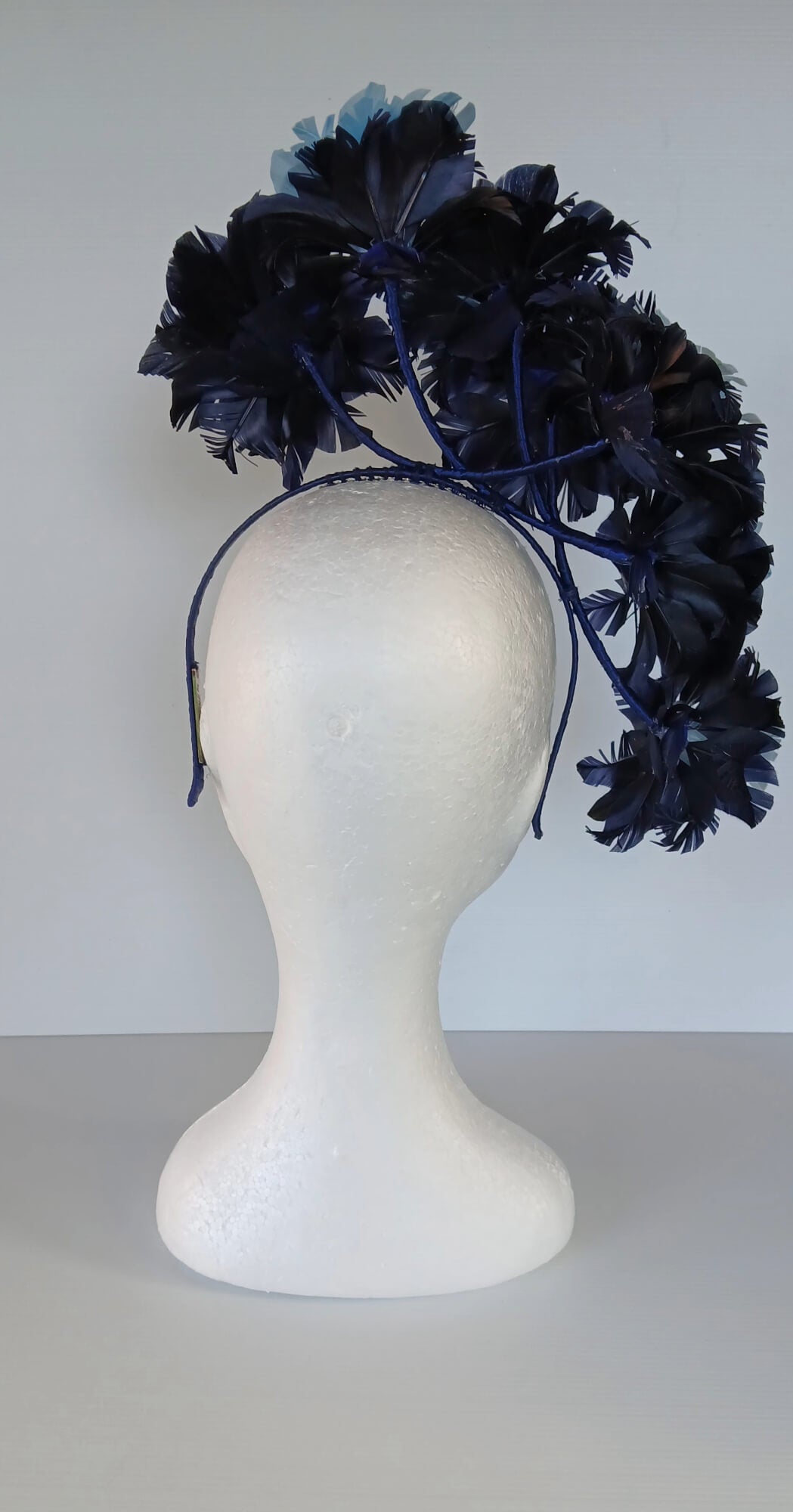 A picture of a Blue Floating Feather Millinery Headpiece by Melissa Rath Millinery.