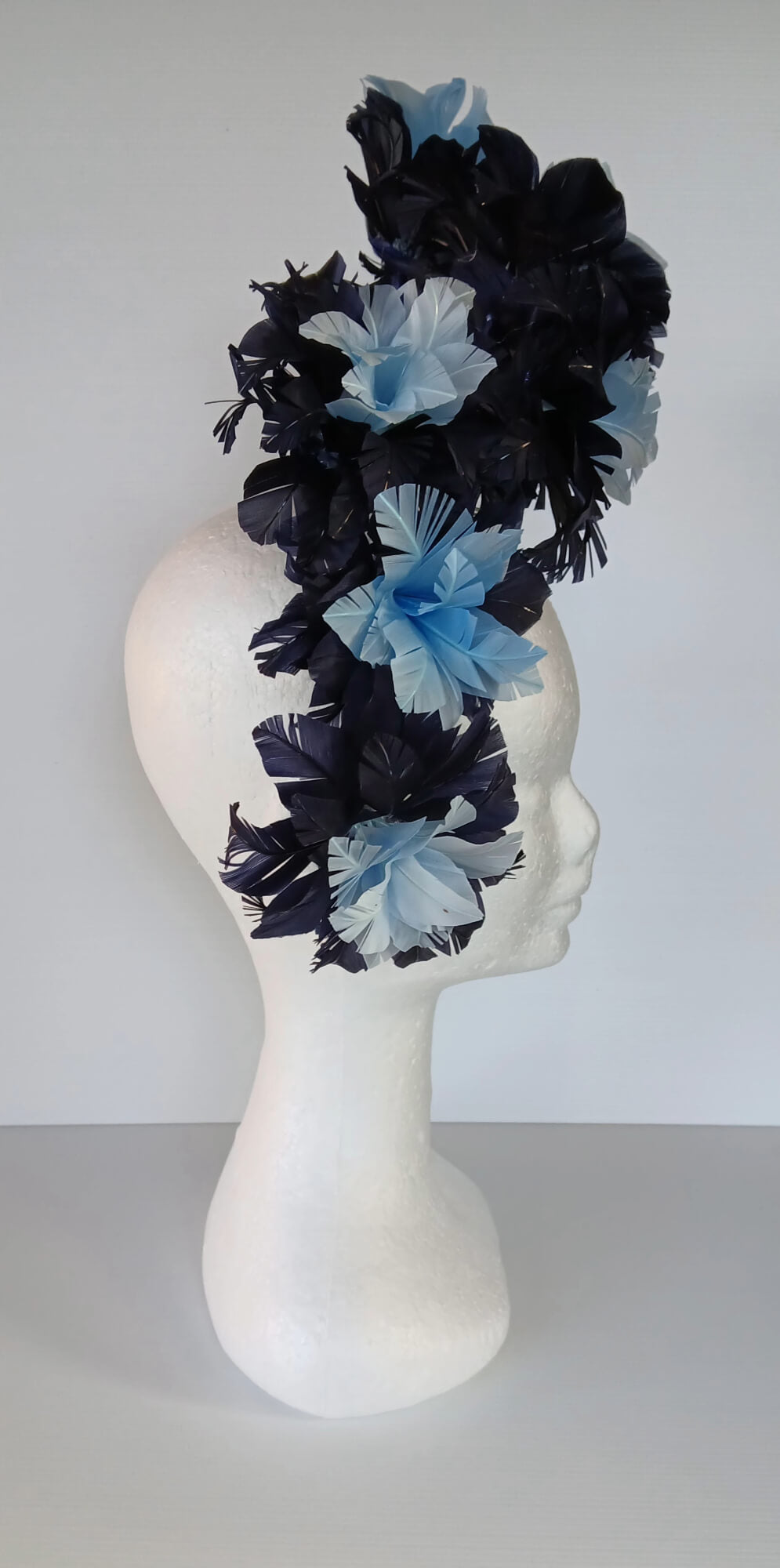 A picture of a Blue Floating Feather Millinery Headpiece by Melissa Rath Millinery.