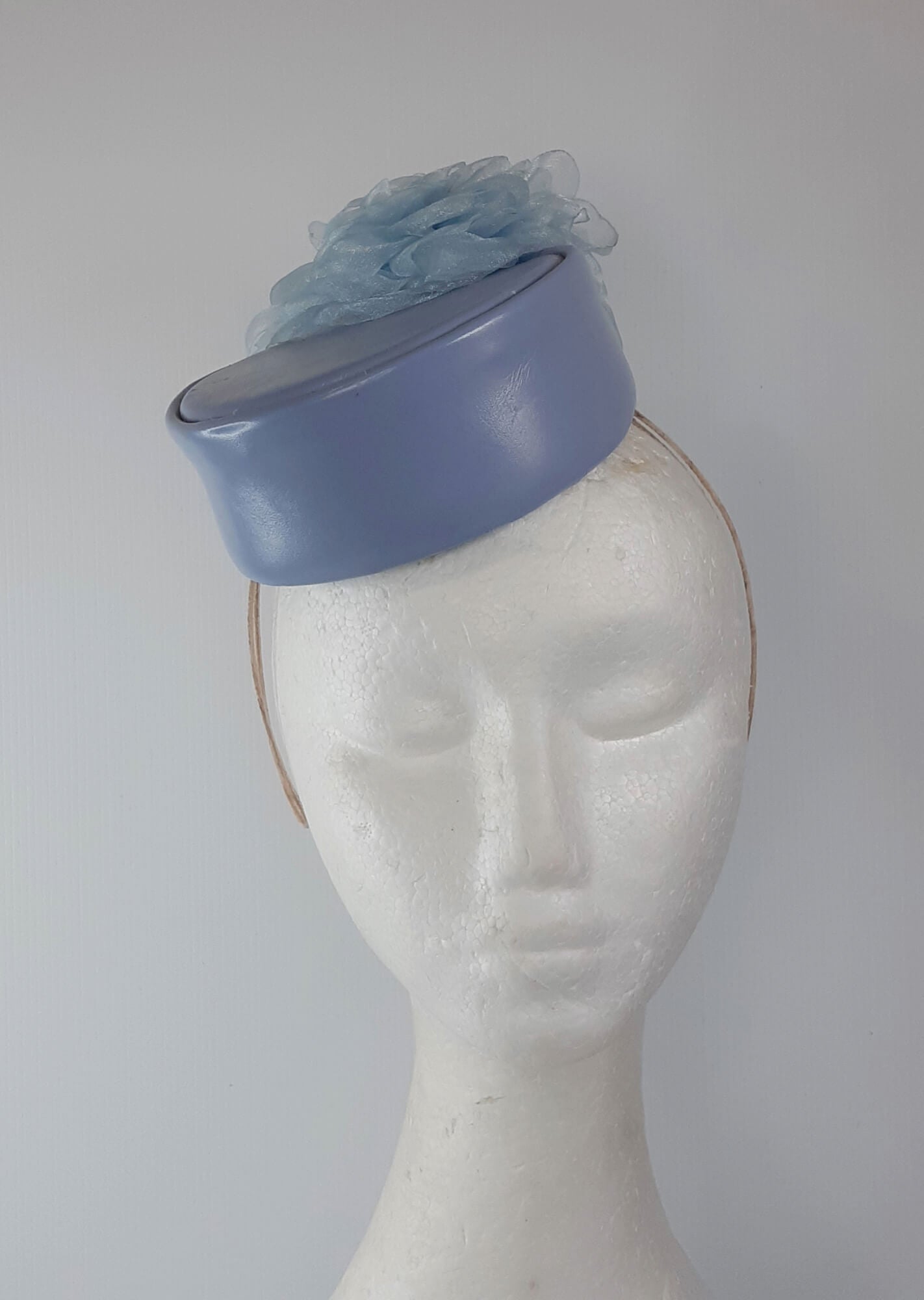 A picture of a Blue Leather Millinery Headpiece by Melissa Rath Millinery.