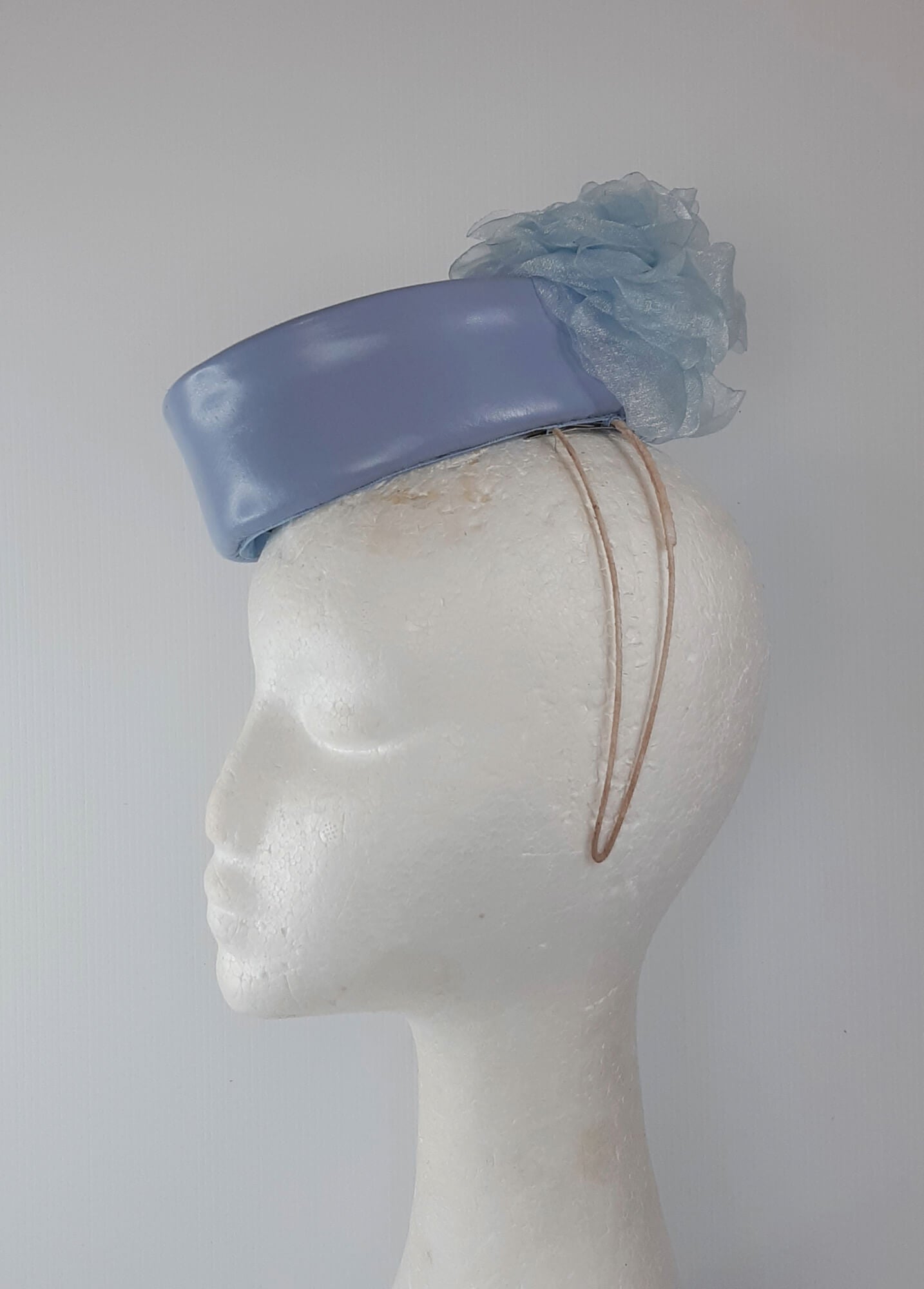 A picture of a Blue Leather Millinery Headpiece by Melissa Rath Millinery.